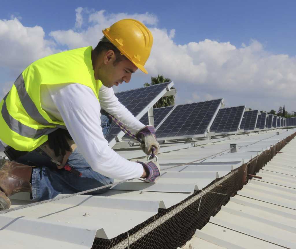 construction engineer working on setting up solar panels